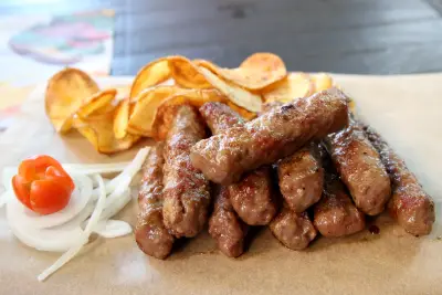 Ćevapi sa roštilja sa čipsom od krompira, lukom i paradajzom u restoranu Stara pivnica u Zemunu